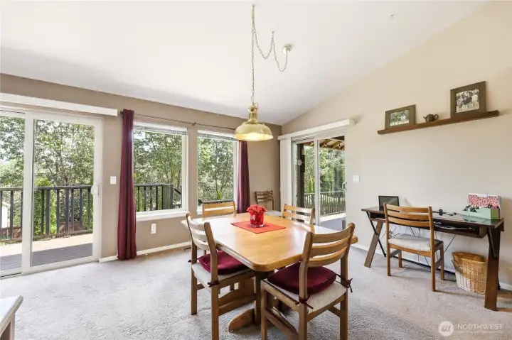 Dining area with multiple sliders onto the large deck.