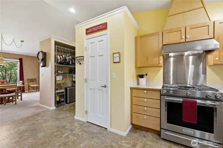 The kitchen features a large enclosed pantry plus additional storage in the hallway.  The stove is a KitchenAid dual-fuel range.