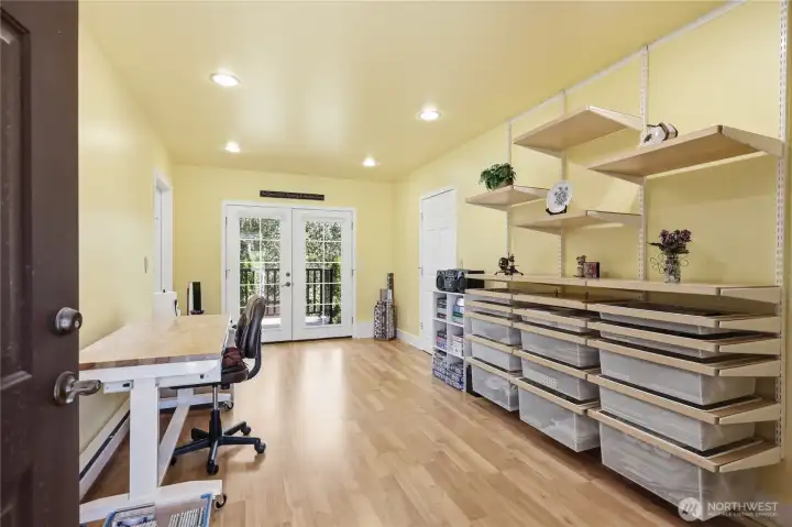 This versatile room has French doors leading to the deck as well as a front door.