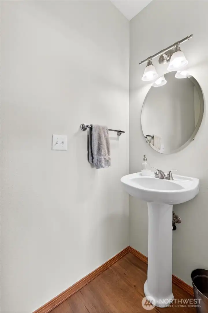 The downstairs powder room is functional with this lovely pedestal sink.