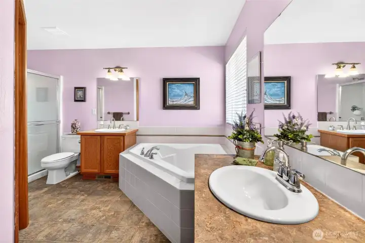 Your 5-piece en suite bathroom includes a glorious soaking tub and separate counters for personalized space.