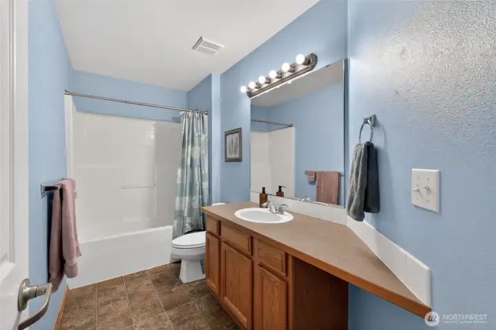 The upstairs secondary bathroom has plenty of space for all.