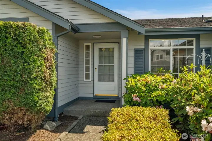 Front porch and mature landscaping.