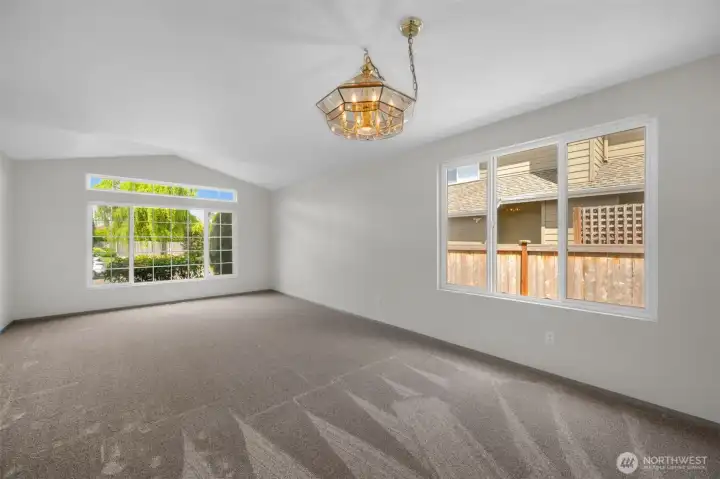Front living room with vaulted ceiling and formal dining room.