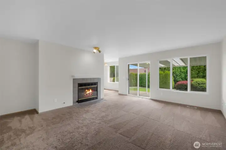 Great little nook for bookshelve. Gas Fireplace and view of the backyard.