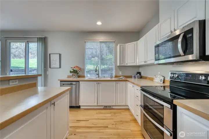 View of the kitchen showing counter space, large window, and sliding door. Plenty of light! View of the kitchen showing counter space, large window, and sliding door. Plenty of light!