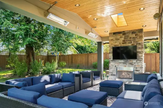 Covered patio with flat screen and fireplace.