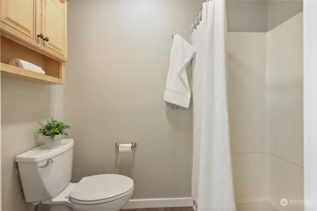 3/4 bath with roomy shower and storage.