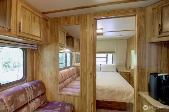 Main living area and view into primary bedroom