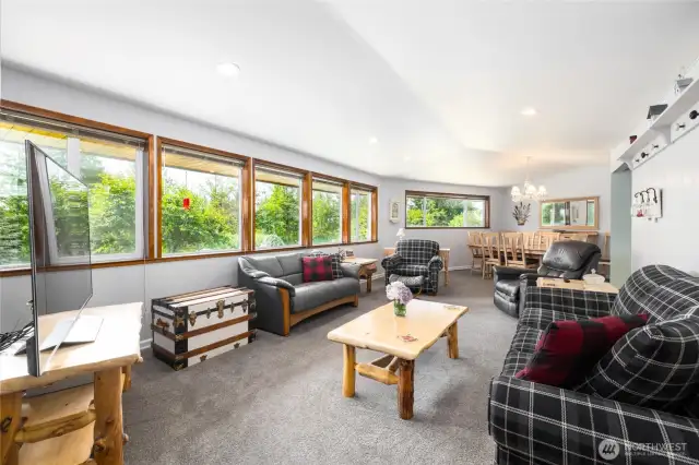 Living Room with new triple pane glazed windows blocking harmful UV Rays, and contributing energy efficiency by deflecting heat to its source. Living Room flows effortlessly into the formal Dining Room.