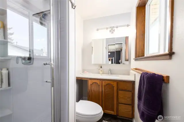 Primary 3/4 bathroom with new shower and quartz countertop.