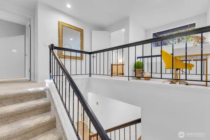 Stairs to the 2nd floor landing. Skylights bring in addiotnal light.