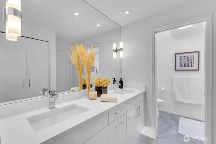 Beautifully updated primary bath with quartz countertops and beautiful walk in shower.