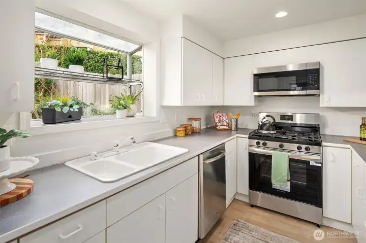 Brand New Stainles Steel gas range, built in microwave & triple door refrigerator.  Garden window overlooks the backyard