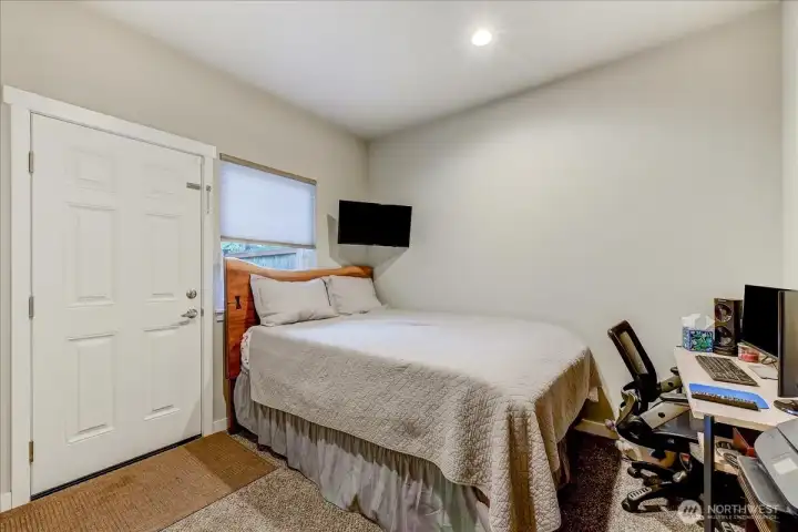 This lower-level bedroom has a closet (not pictured) and a door to the patio & fenced backyard.  Would make a great office or guest room, as it is currently being used as.