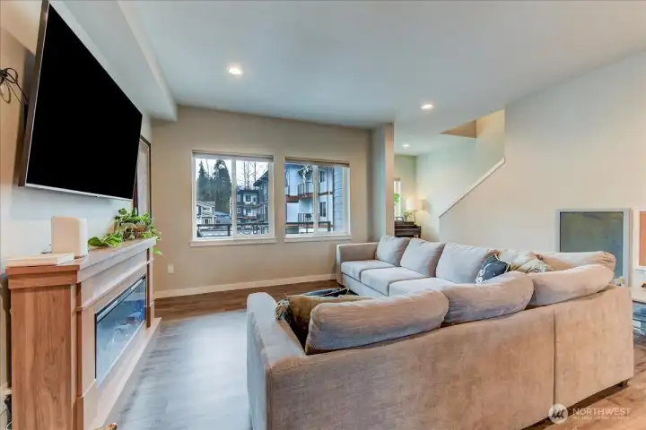 Great room with recessed lighting and the same laminate vinyl flooring throughout.  Large picture windows face the east and bring in the morning sunlight.
