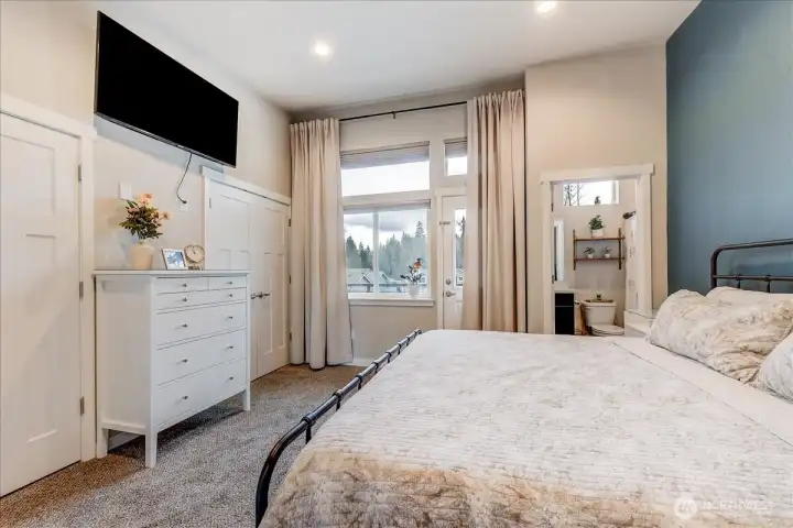 Primary suite with 2 closets, vaulted ceilings, balcony and a full bath.