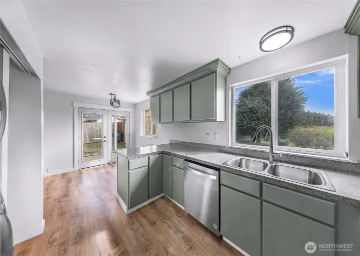 Window overlooks the back yard. French doors leading to patio/yard