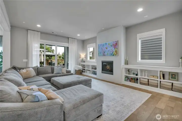 Floor-to-ceiling stone fireplace serves as the focal point of the Great Room. Custom built-ins flanking the fireplace add style and storage.