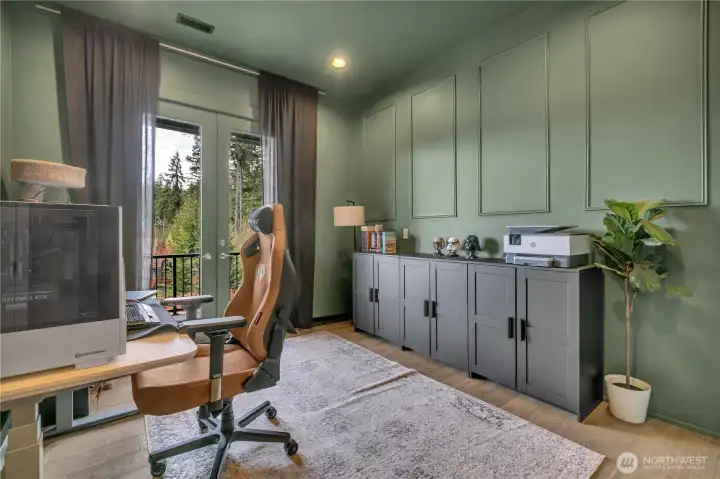 Fourth bedroom on the main level or office, featuring French doors opening to private balcony. Fourth bedroom on the main level or office, featuring French doors opening to private balcony.