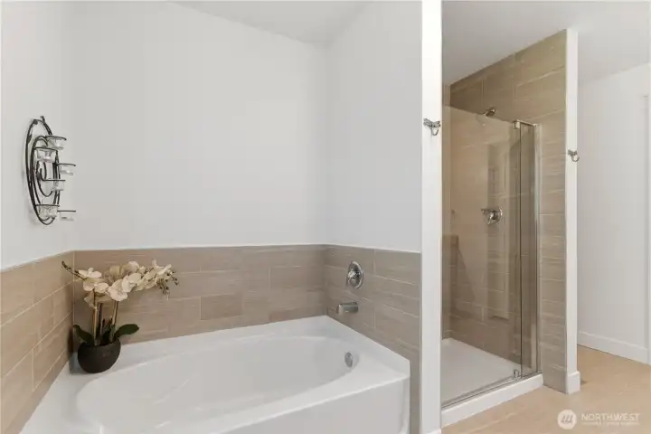 Primary bathroom with soaking tub and walk-in shower.