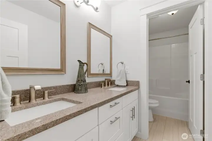 Hall bathroom with updated cabinetry and dual-sink vanity.