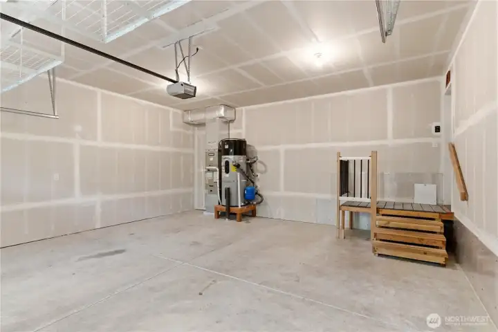 Oversized attached garage with room for vehicles and gear.