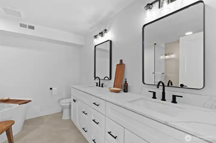 Primary bathroom with double sinks, soaking tub, and walk-in shower. Primary bathroom with double sinks, soaking tub, and walk-in shower.