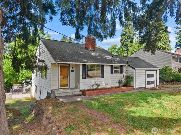Welcome home. Nestled beneath mature evergreens on a corner lot, this classic home offers timeless curb appeal and a setting that feels tucked away while still being close to everything you need.