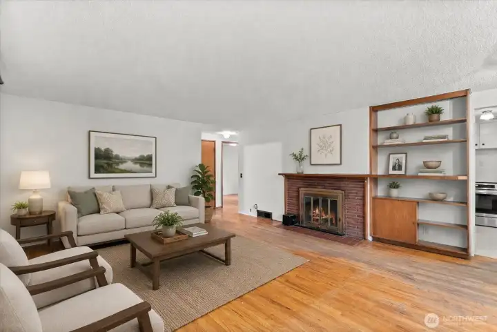 The spacious living room welcomes you with warm hardwood floors, abundant natural light, and a layout that offers plenty of flexibility for everyday living and entertaining. Virtually staged.