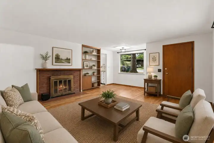 A classic brick fireplace and built-in shelving add character and charm, creating a comfortable gathering space that feels inviting from the moment you walk in.