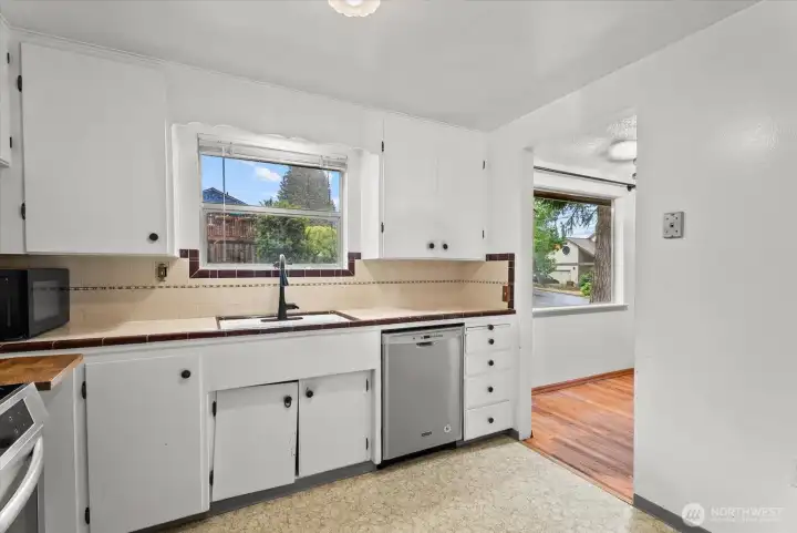 Additional kitchen view highlighting the sink area, built-in storage, and natural light.