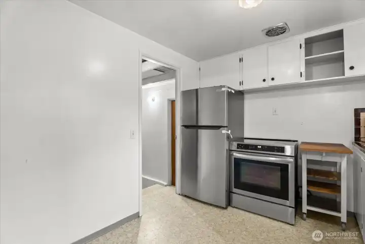 Functional kitchen with white cabinetry, stainless steel appliances, and ample storage.