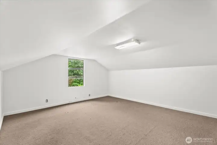 Another view of the upstairs bedroom room showcasing the generous size and versatile layout.