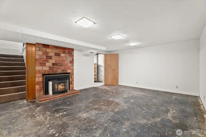 Large flexible living space with a brick fireplace and plenty of room to create a media room, game room, home office, or additional gathering area.