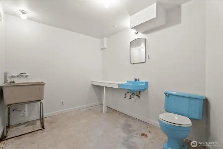 Additional bathroom featuring a sink, toilet, and utility wash basin.