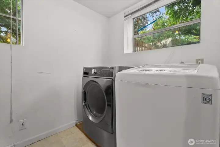Dedicated laundry room with space for side-by-side washer and dryer.
