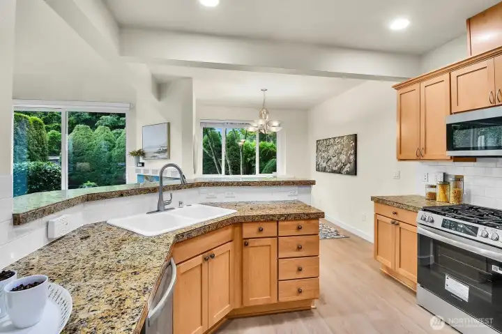 The open kitchen features brand-new stainless steel appliances, making meal preparation easier while keeping you connected to the living and dining areas.