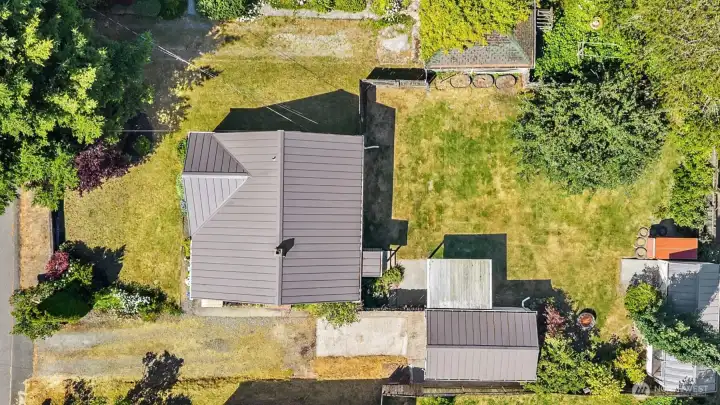 Lot showcasing home, storage shed, off street parking, & detached garage.