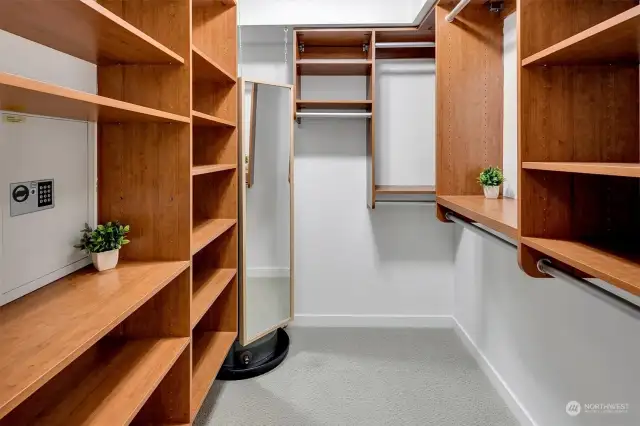 Large walk-in closet with custom closet system, personal safe and hanging mirror!