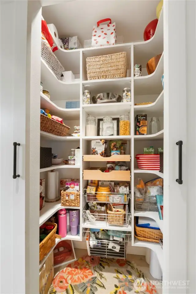 Your dream pantry with slide outs, wooden shelving and double doors awaits your next grocery run and cooking & baking time