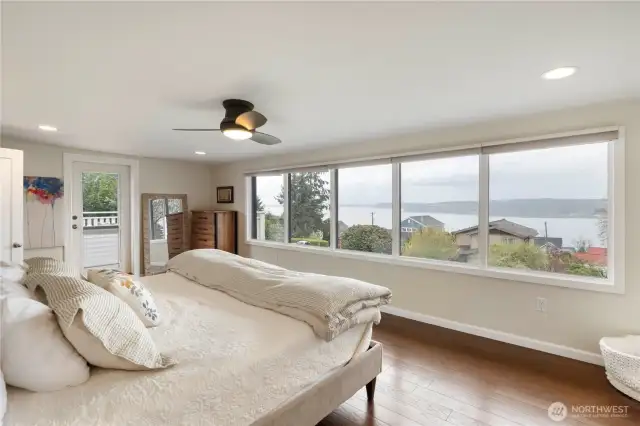 The upper level primary suite has sweeping views & engineered hardwood flooring. The side door leads to your private view deck where you can enjoy your morning coffee or evening glass of wine. Imagine waking to those gorgeous views each day