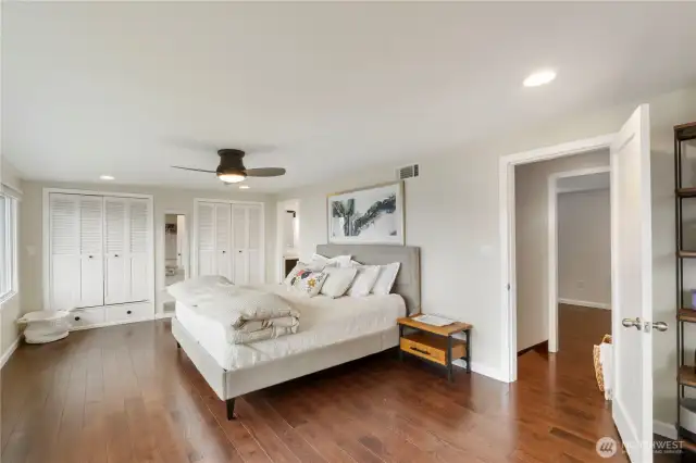 The primary suite offers built-in, cedar lined double closets and the door to the right leads to the 4th bedroom or perfectly placed office/den