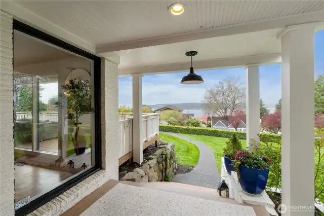 Stone steps from the front parking area and a winding sidewalk lead to the charming covered porch and there is a gate to the main level view deck
