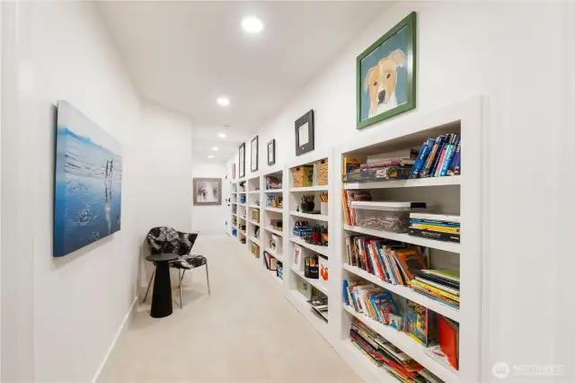 Did we mention all the storage & built-in shelving available at the lower level?! This hallway leads to the 2 car garage and is accessible from all rooms at the lower level. Easy access from one end of the home to the other