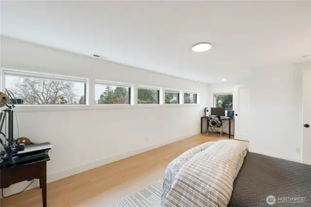 New windows add a vast amount of light and the door to the right of the game area leads to the large walk-in closet with built-in shelving