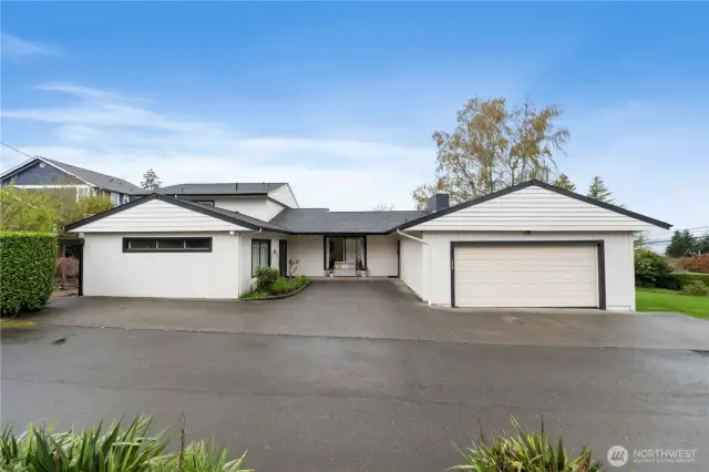 The quiet alley side of the home shows the 2 car garage and added parking off the back entrance