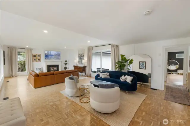 The hallway to the right leads to the doorway of the back entrance and the main level primary suite. This entrance sits near the 2 car garage & added parking and has no steps for homeowners or guests with limited mobility