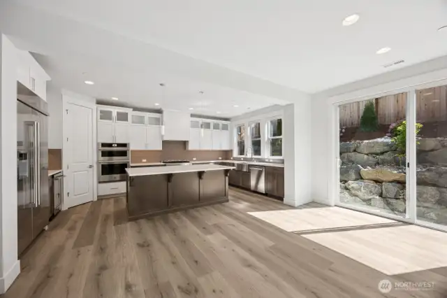 JennAir appliances, pantry, quartz counters, beverage fridge, and full height back splash
