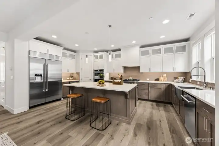 A kitchen fit for a chef! JennAir appliances, quartz counters, beverage fridge, double ovens, gas range, pantry, and fridge included!